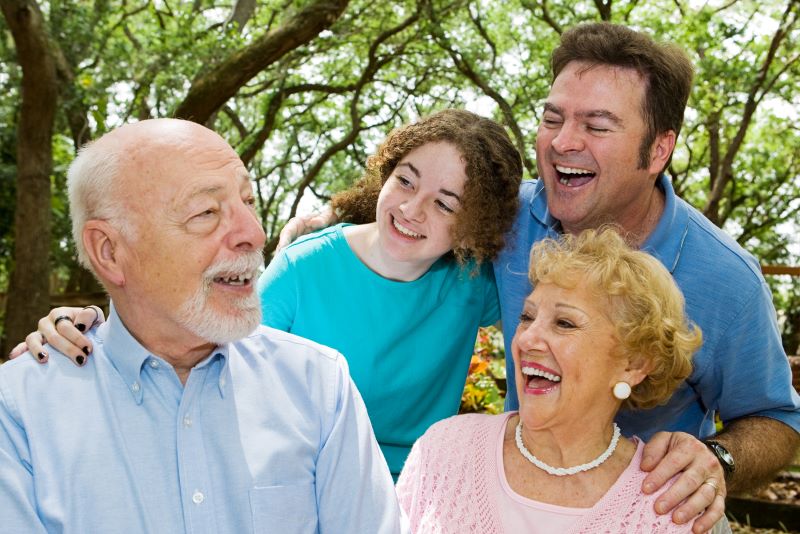 multigenerational family laughing outdoors