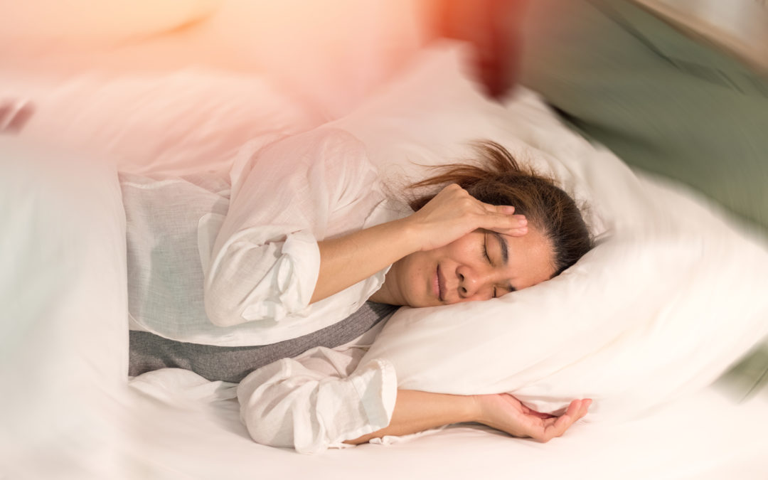 woman suffering from dizziness in bed