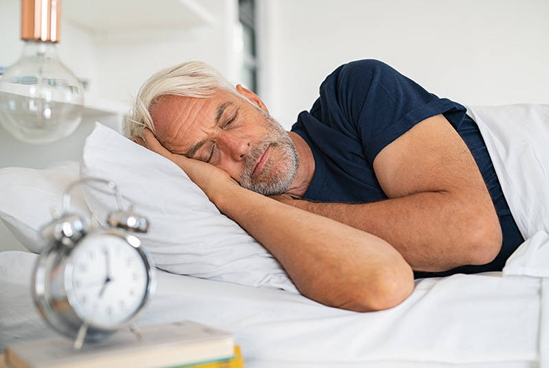 A senior man not wearing his hearing aids to bed