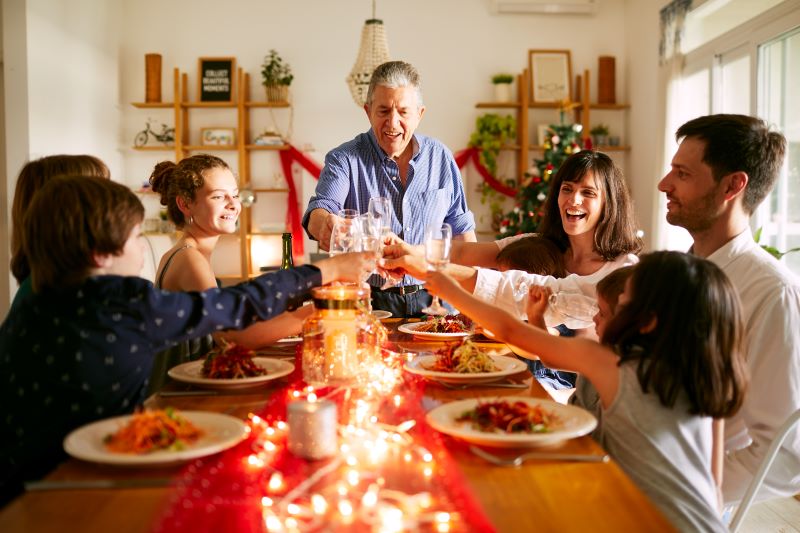 grandfather experiencing hearing loss enjoys holiday dinner with his family
