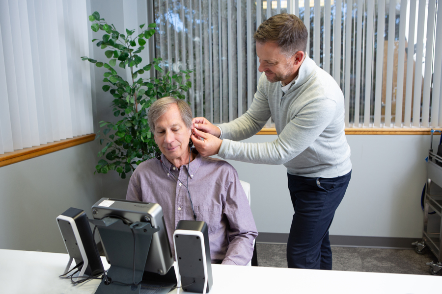 Matt Wilken working with a hearing patient at the Colorado Ear Care office