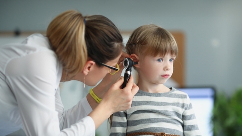 Child getting ears checked.