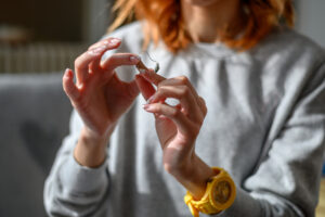 lady holding hearing aids.