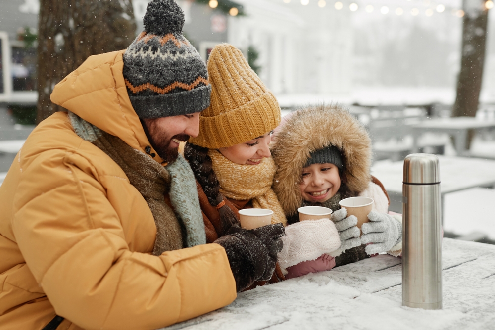 Family playing outside in the snow.