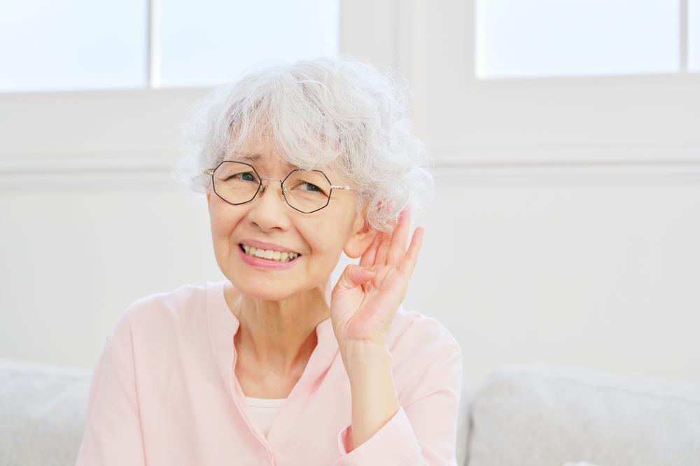 Older lady having trouble hearing.